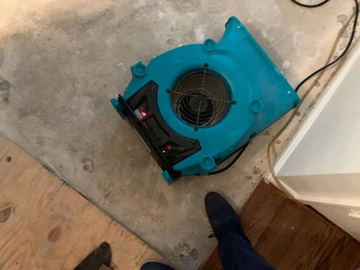 Air mover drying subfloor during Commercial Water Damage Restoration in Creve Coeur